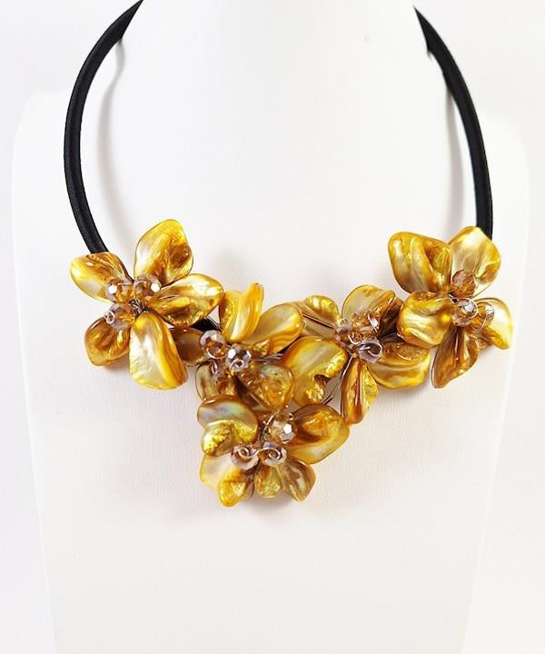 Yellow shell petal flower clusters wire-wrapped on a black cord collar with rhinestone centers, view 2