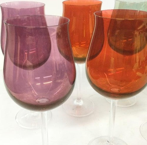 Eight long-stem wine glasses with green, orange, purple and red bowls and clear stems, view 2