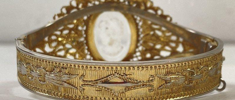 Signed Whiting and Davis gold-tone hinged bracelet with clear intaglio portrait cameo, view 2