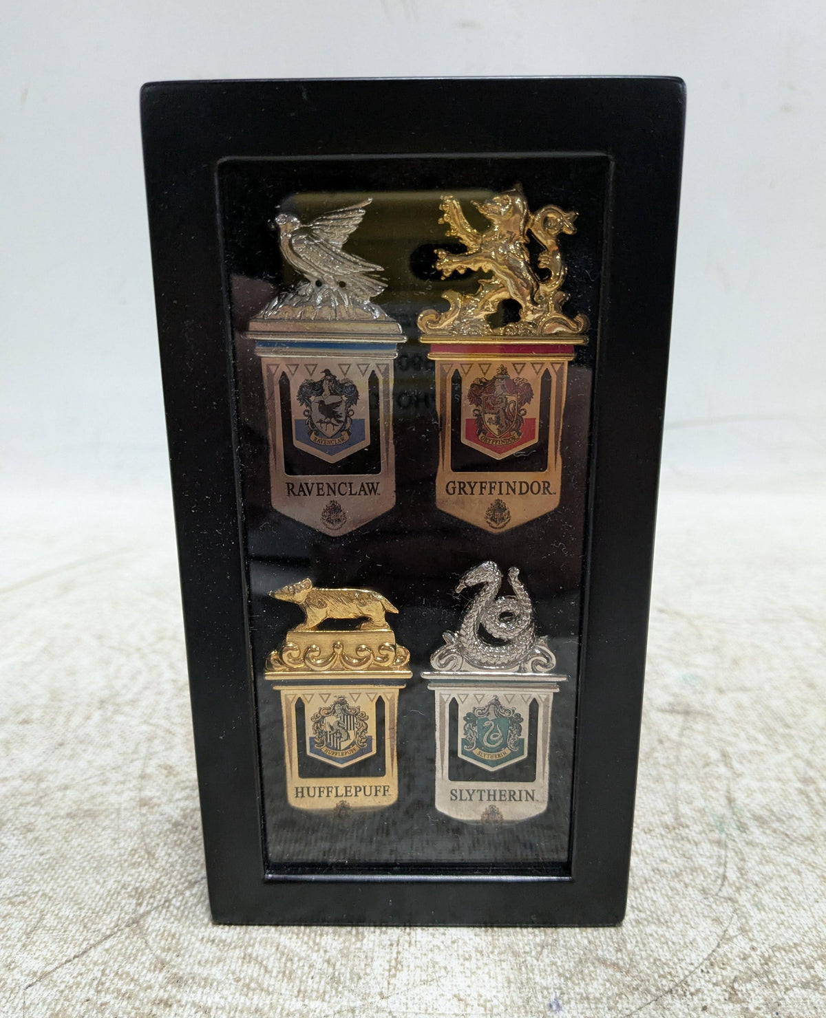 Four metal bookmarks with Hogwarts house crest designs, view 2