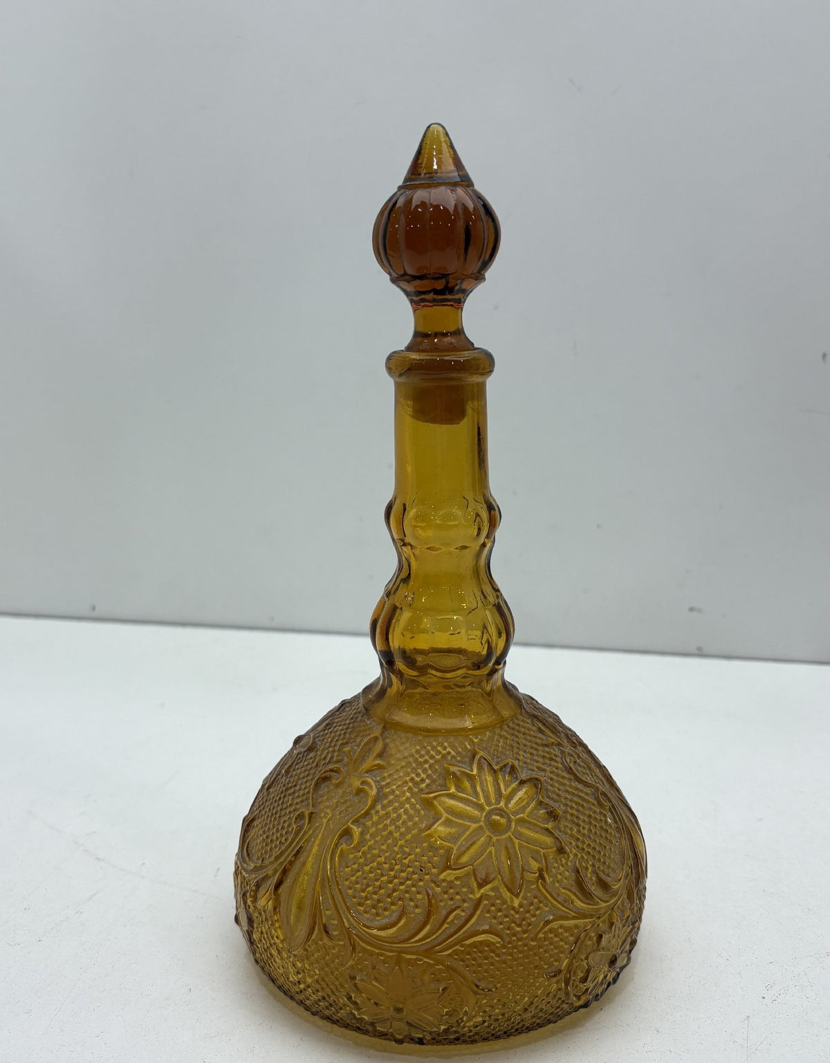 Amber glass genie bottle decanter with embossed floral pattern and stopper, view 5