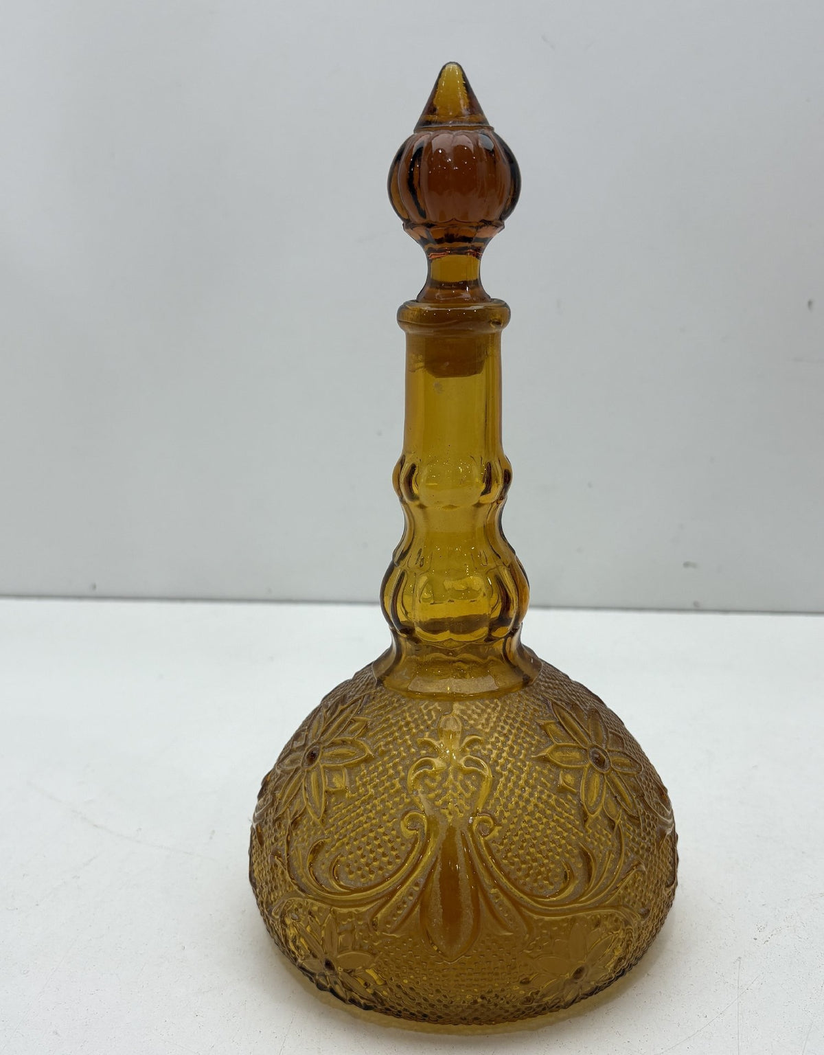 Amber glass genie bottle decanter with embossed floral pattern and stopper, view 6