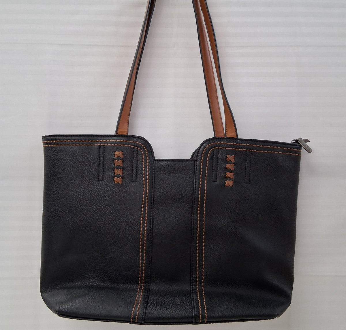 Black faux leather tote with brown handles and brown accent stitching, view 6