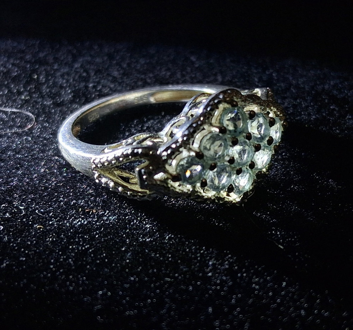 Silver cluster ring stamped 925 with round blue stones and scrollwork shoulders, view 7