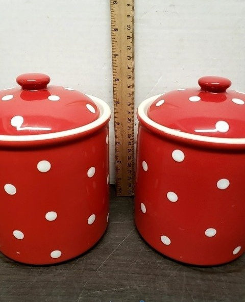 Three graduated red ceramic canisters with white polka dots and lids, view 3