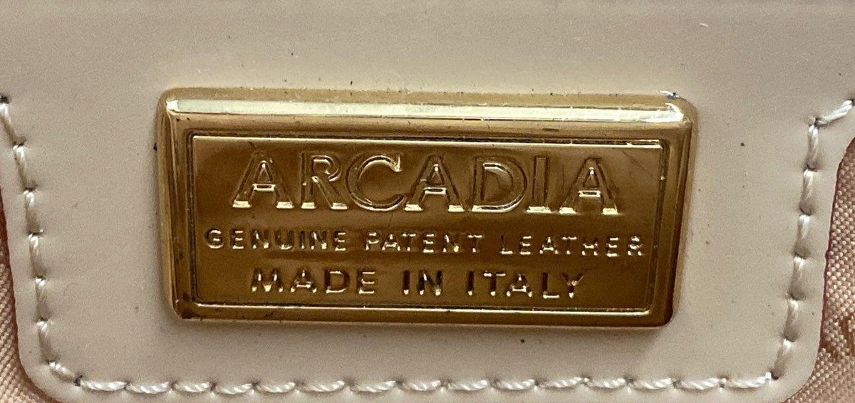 Arcadia cream patent leather sling bag with flap front and gold-tone brand plate, view 5
