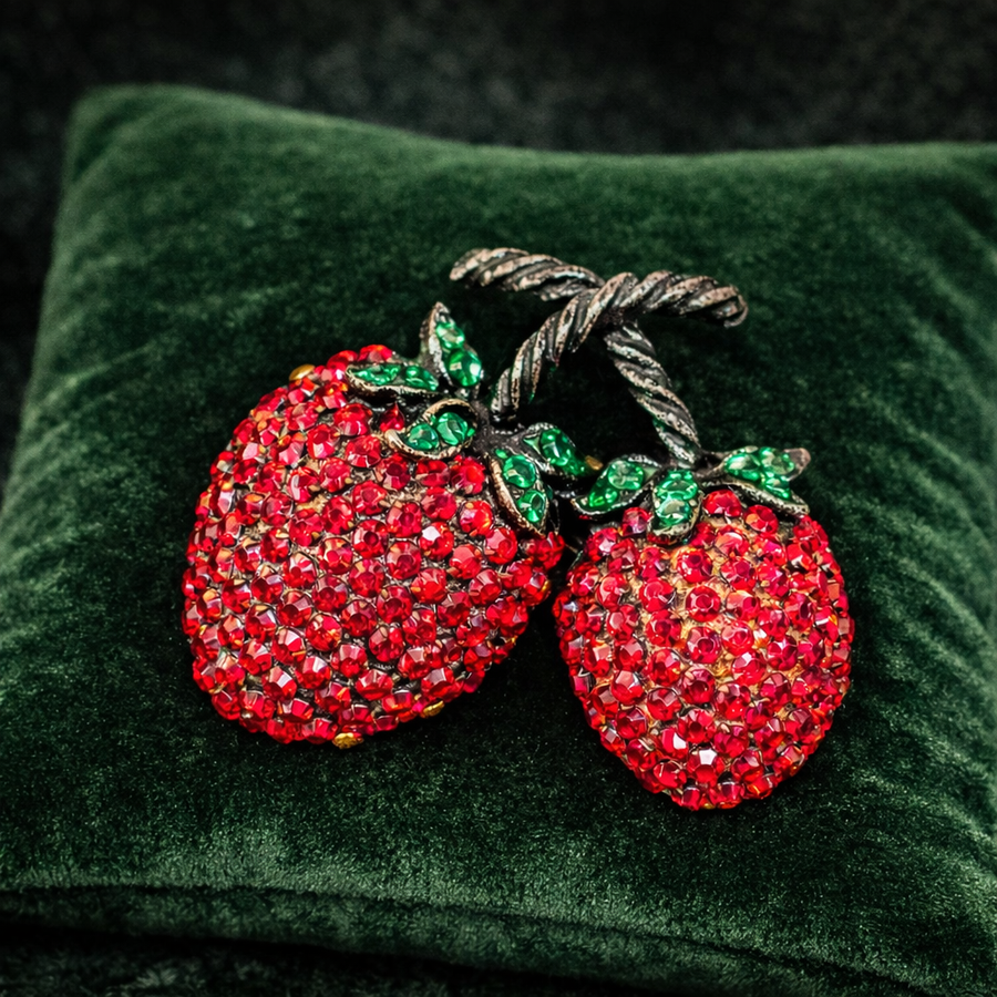 Double cherry brooch with red pavé rhinestones, green rhinestone leaves and copper-tone stem
