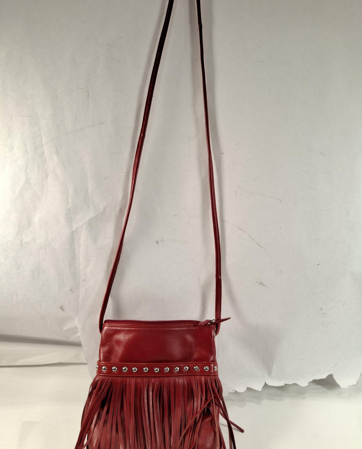 Red leather crossbody bag with front fringe and silver-tone studs, view 2