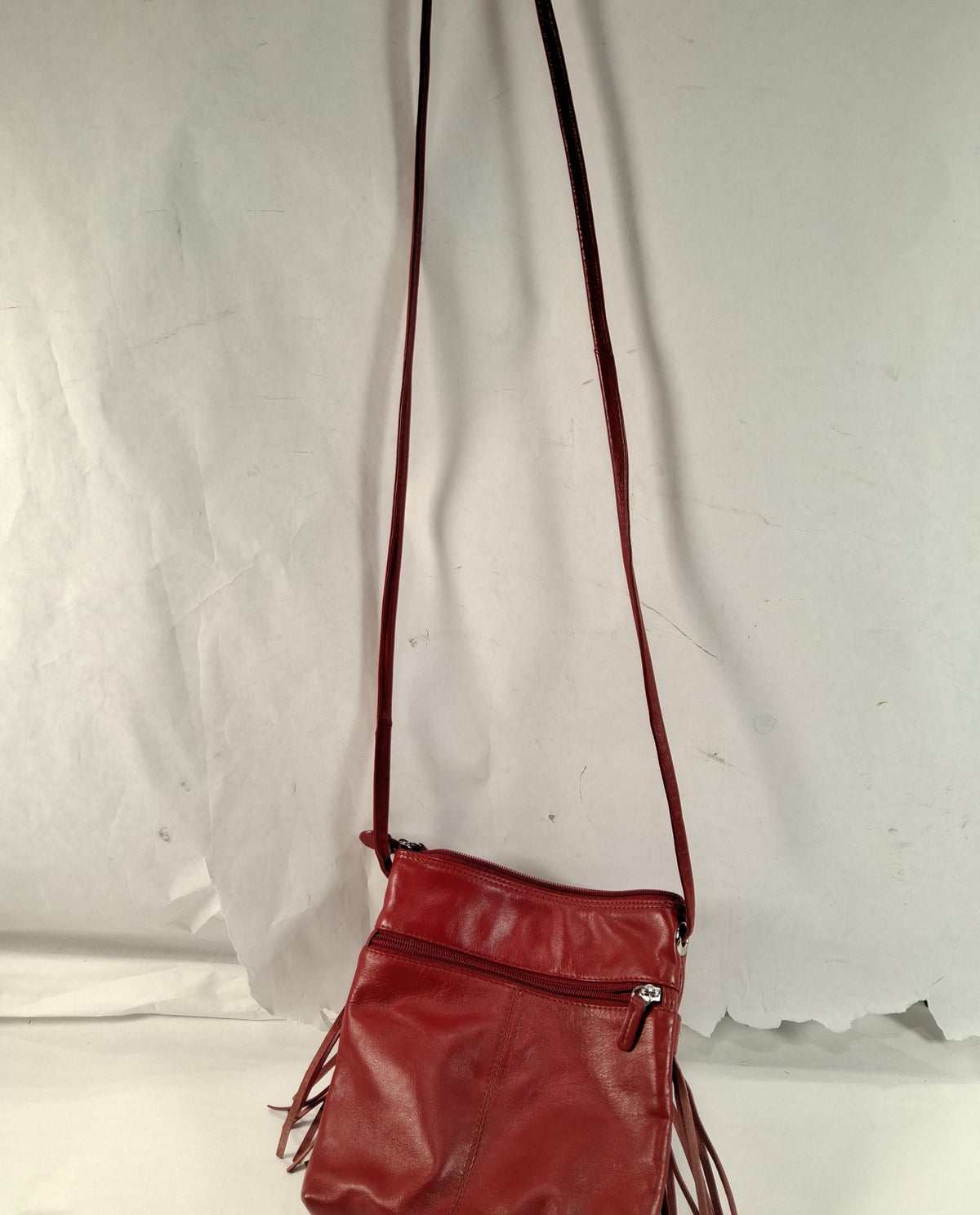 Red leather crossbody bag with front fringe and silver-tone studs, view 3