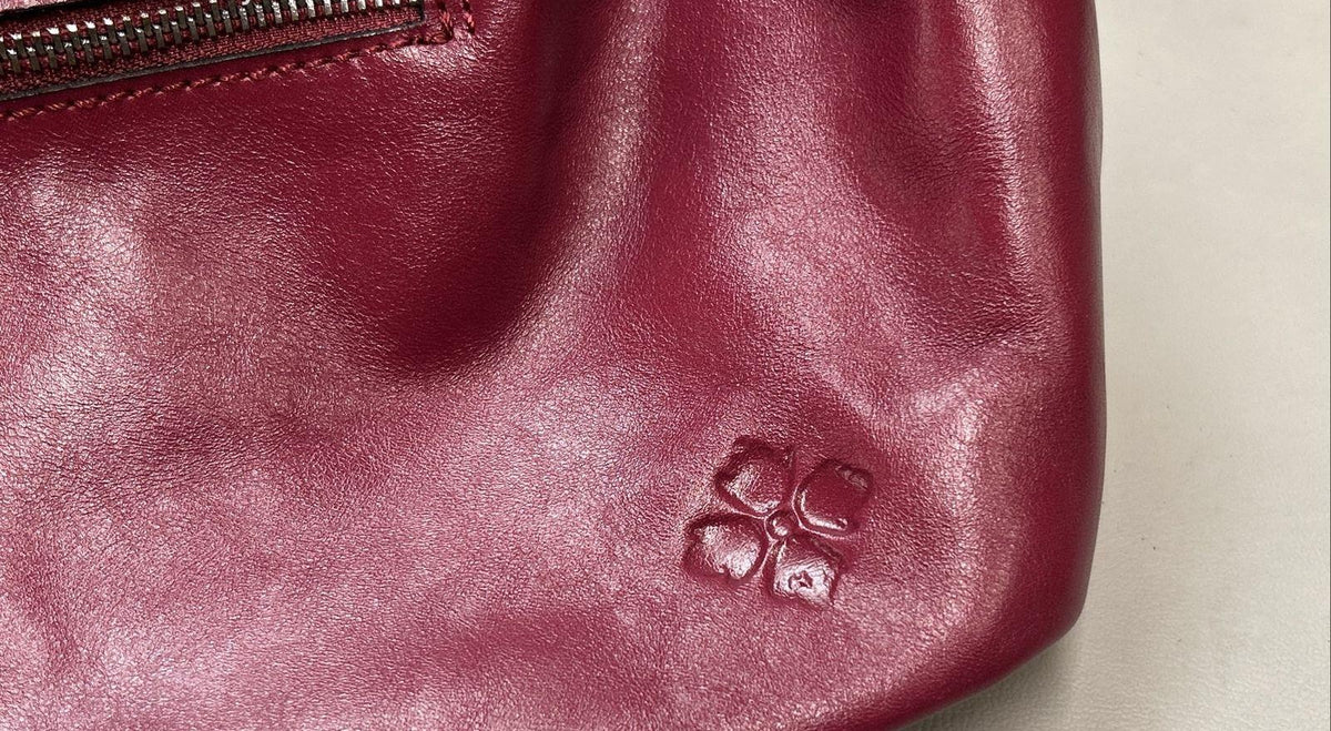 Magenta woven leather satchel with rolled top handle, crossbody strap and silver-tone hardware, view 10