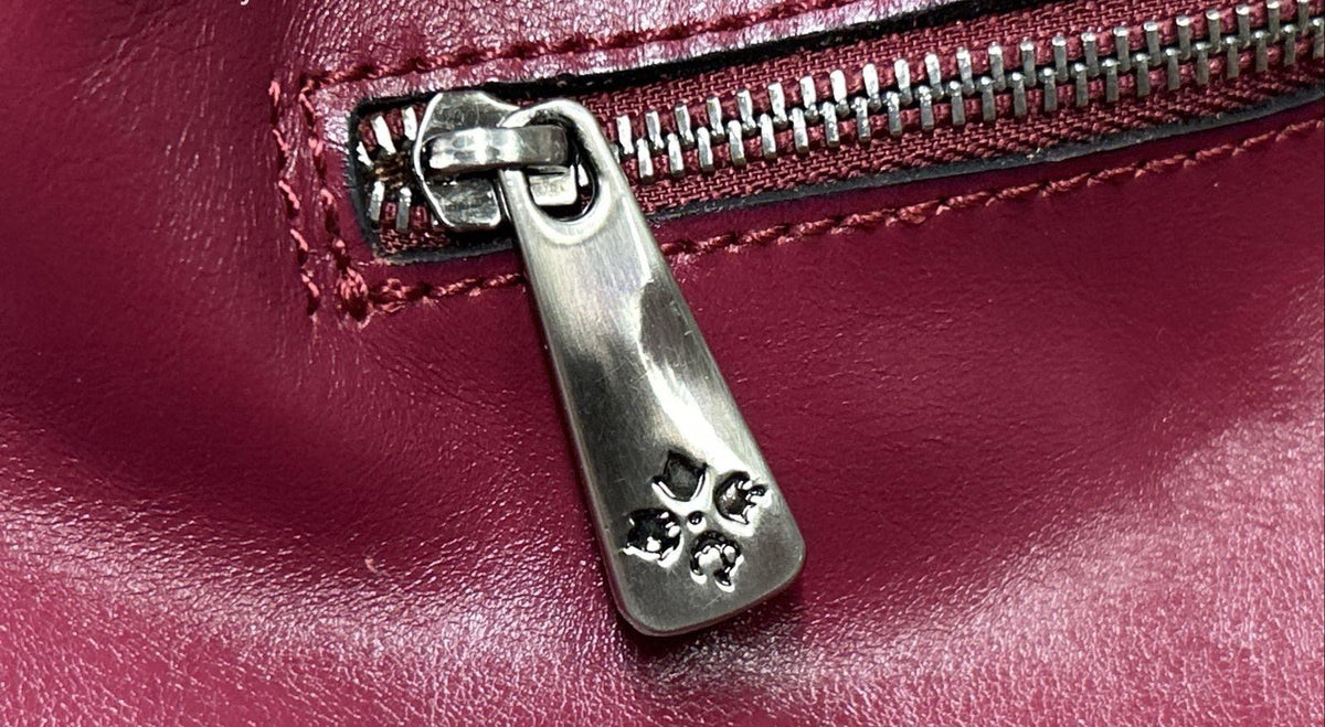 Magenta woven leather satchel with rolled top handle, crossbody strap and silver-tone hardware, view 11