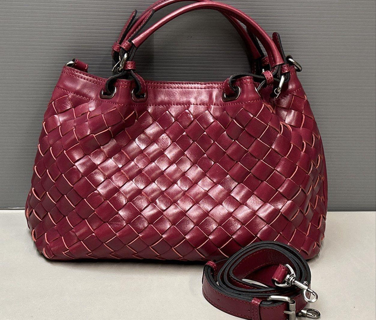 Magenta woven leather satchel with rolled top handle, crossbody strap and silver-tone hardware, view 12