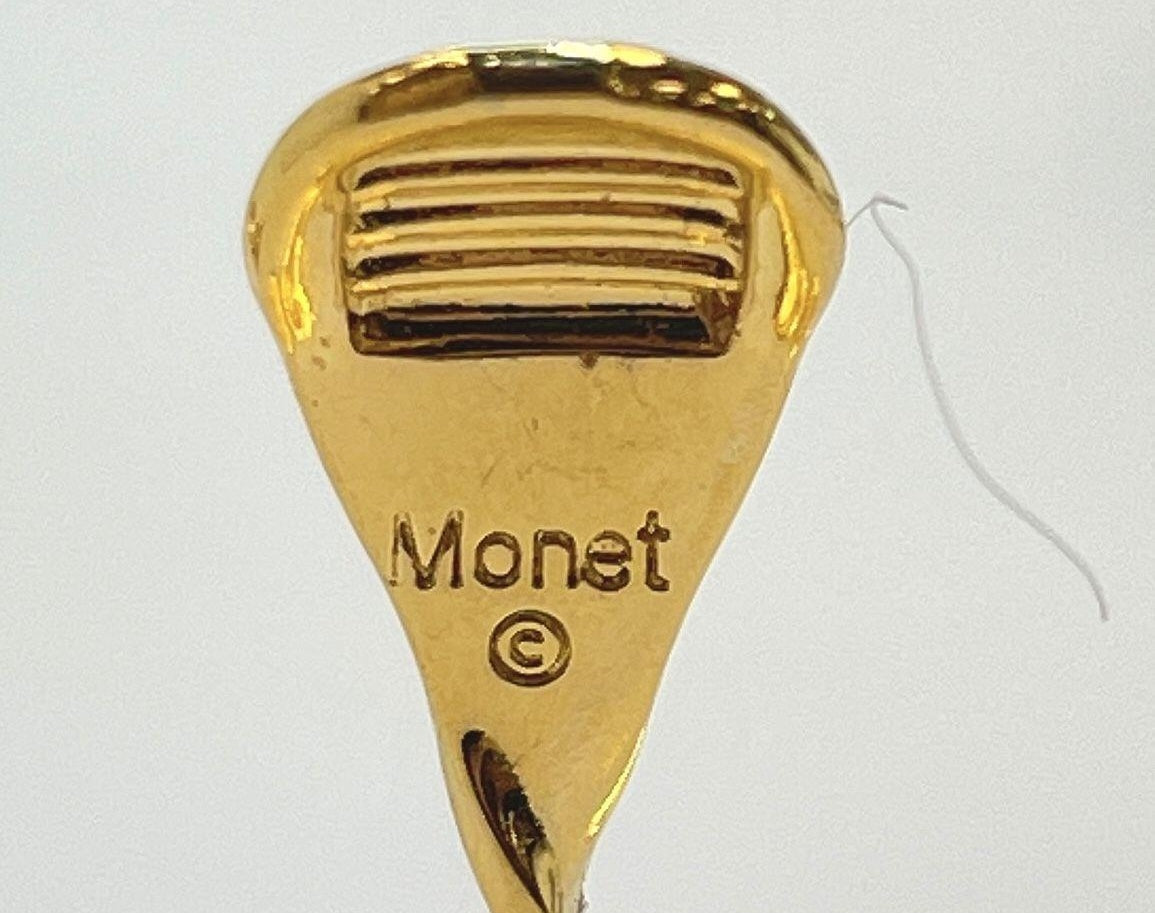Signed Monet gold-tone clip-on earrings with cream enamel petals and black stone centers, view 5