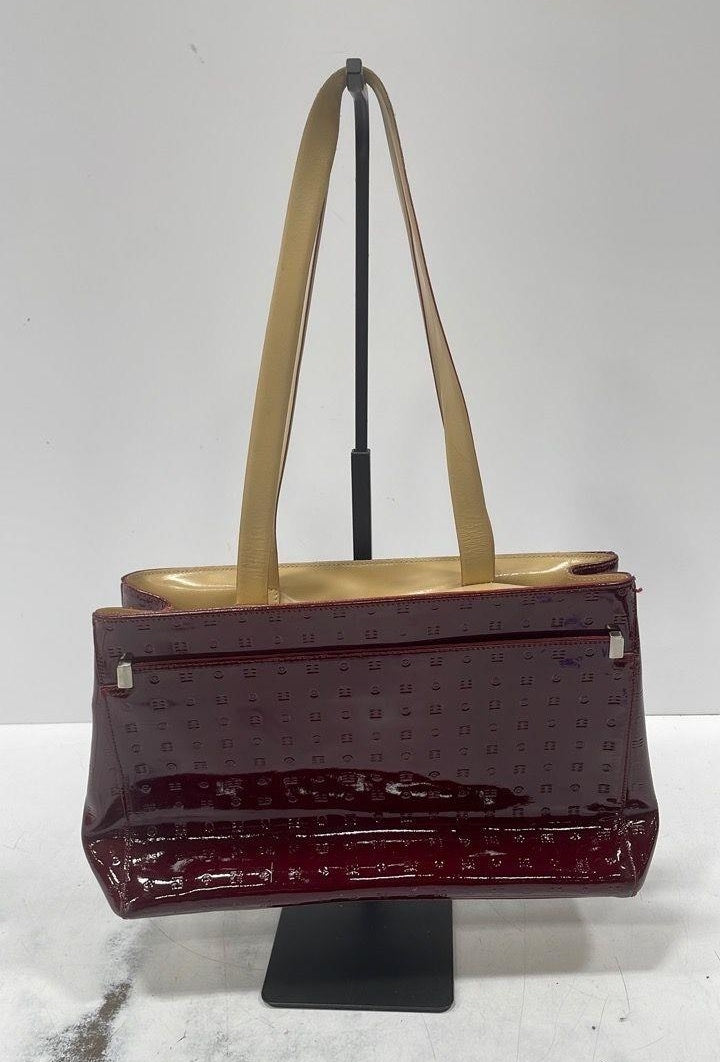 Burgundy patent tote with tan handles and structured rectangular shape, view 3