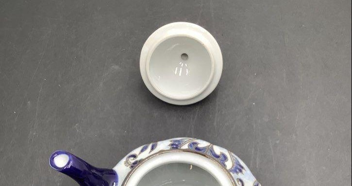 White ceramic teapot with cobalt blue floral and scroll decoration and finial lid, view 6