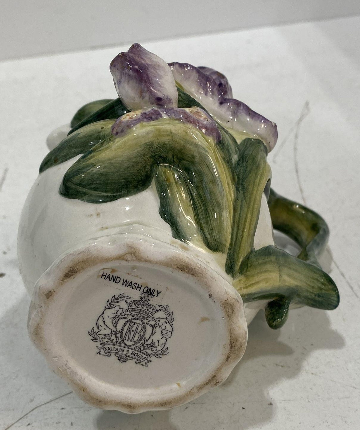 Kaldun and Bogle white ceramic creamer with raised iris flowers and green leaves, view 5