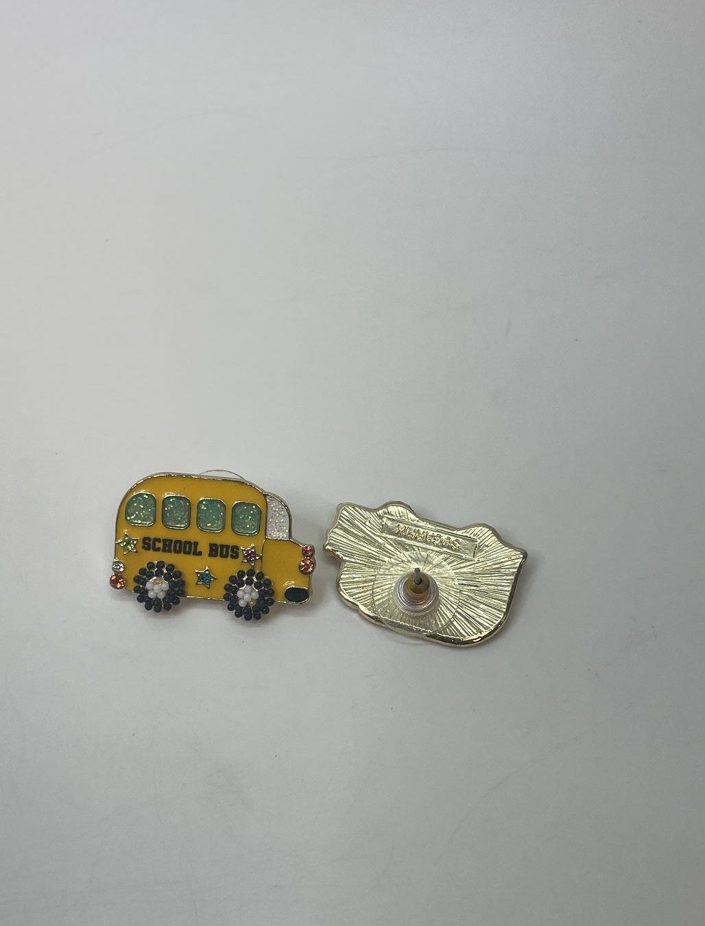 Yellow enamel school bus stud earrings with black and white details, view 2