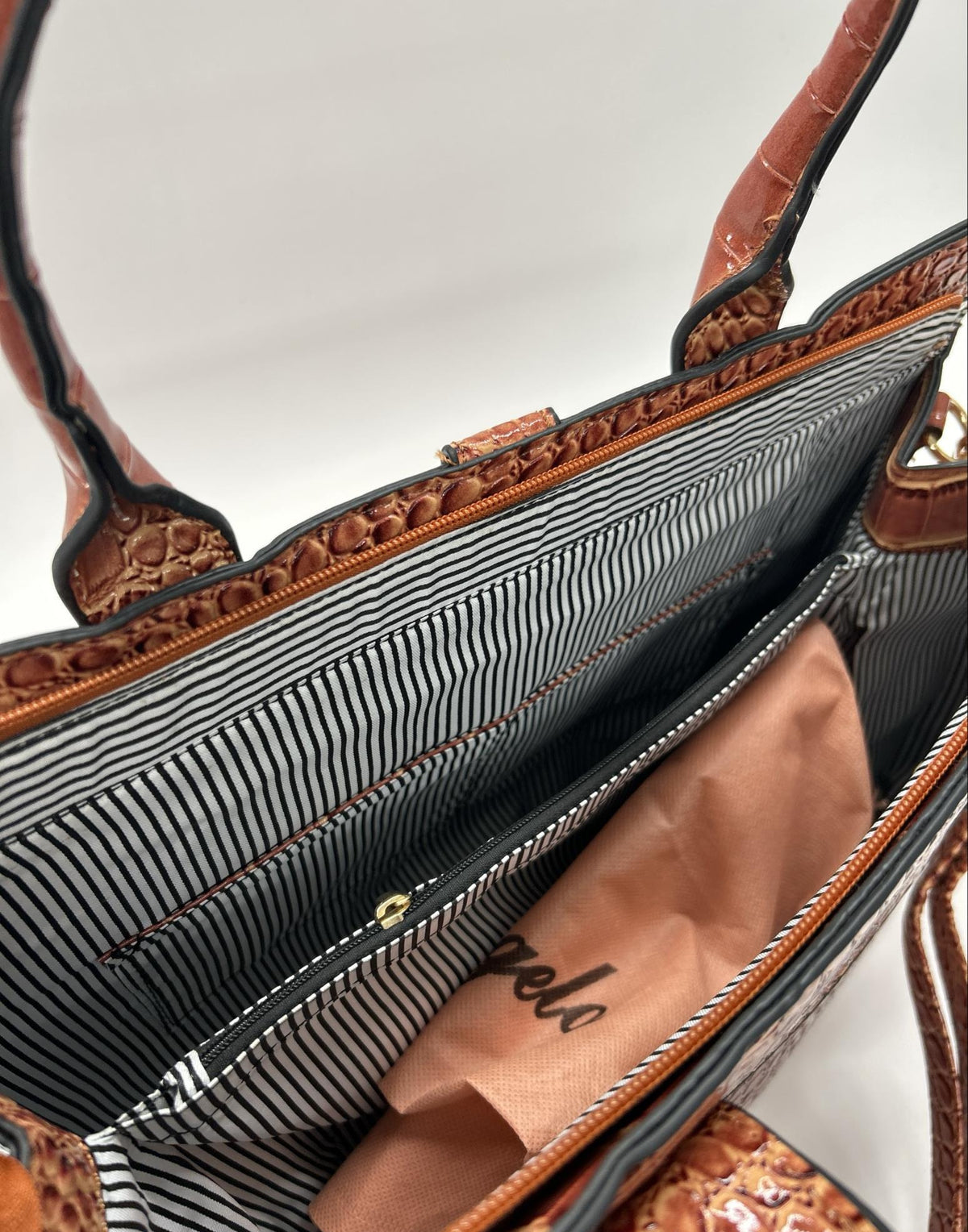Glossy cognac brown croc embossed satchel with matching wristlet pouch and strap, view 5