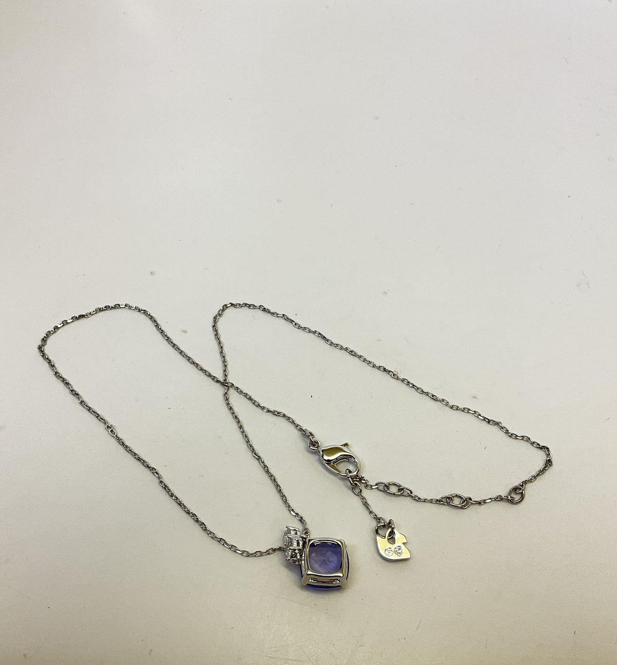 Silver-tone pendant necklace with faceted purple crystal drop on fine chain, view 3