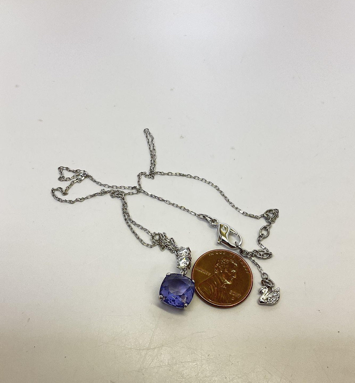 Silver-tone pendant necklace with faceted purple crystal drop on fine chain, view 4