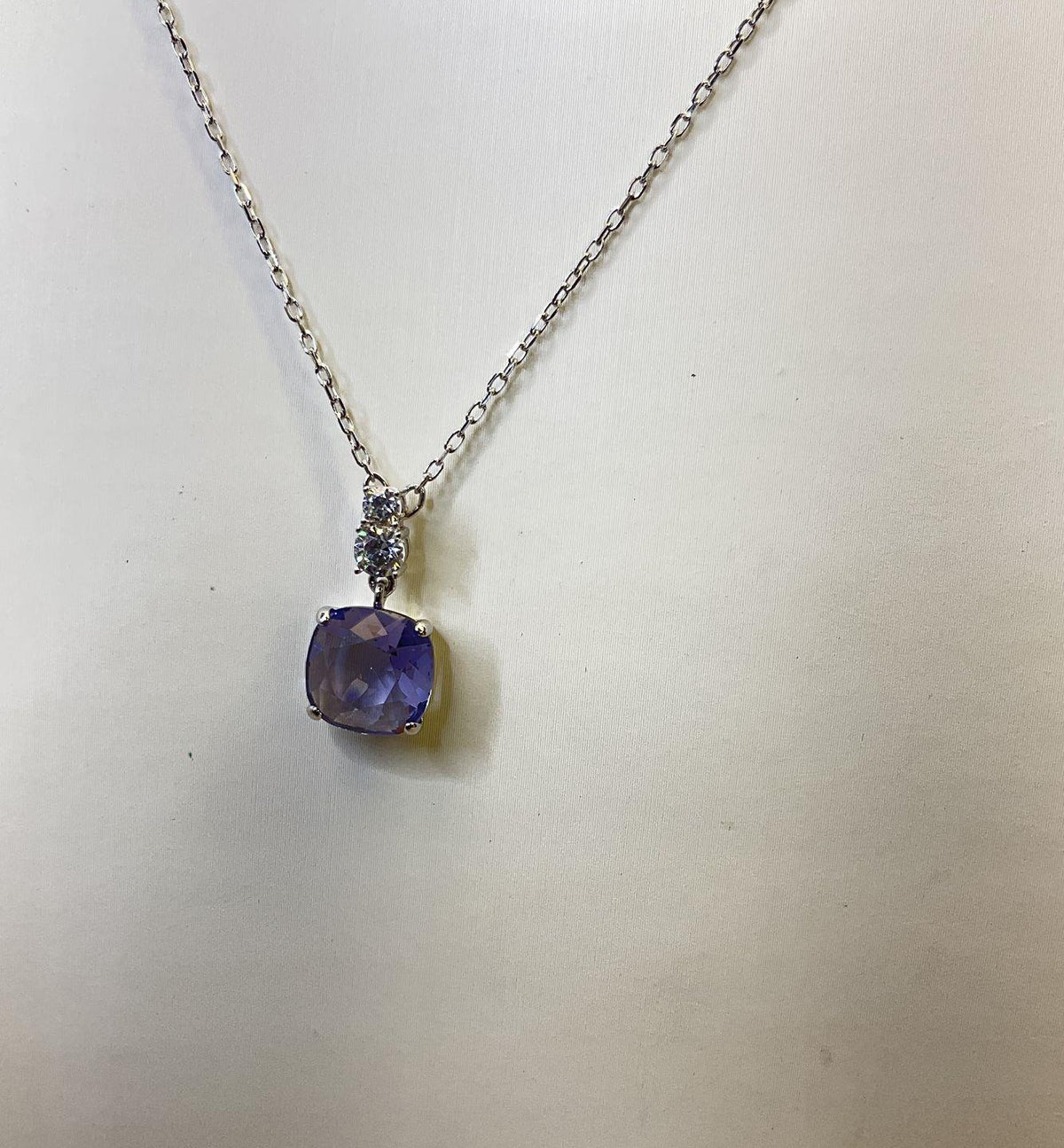 Silver-tone pendant necklace with faceted purple crystal drop on fine chain, view 2