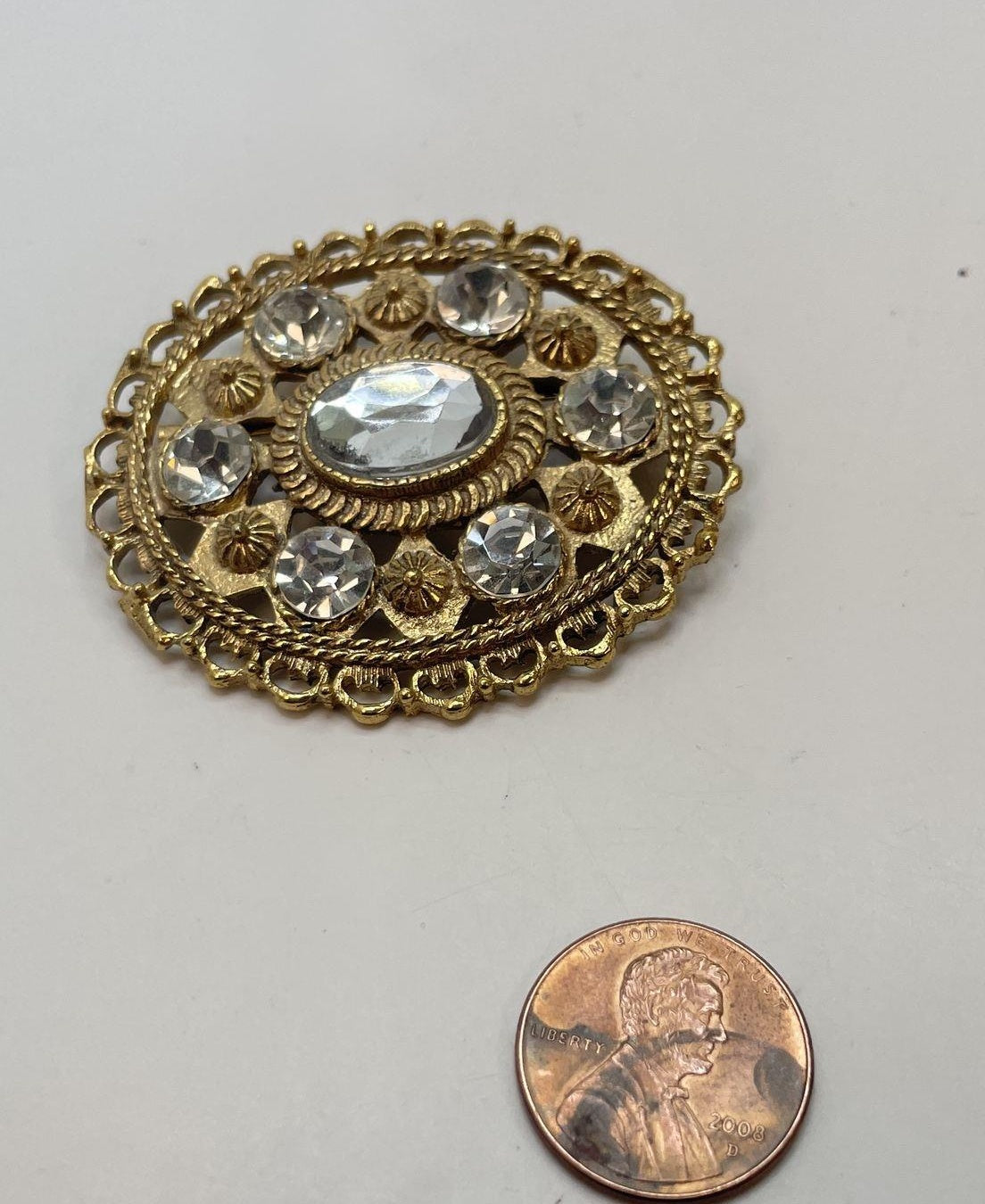 Gold-tone domed oval filigree brooch with clear rhinestones, view 4