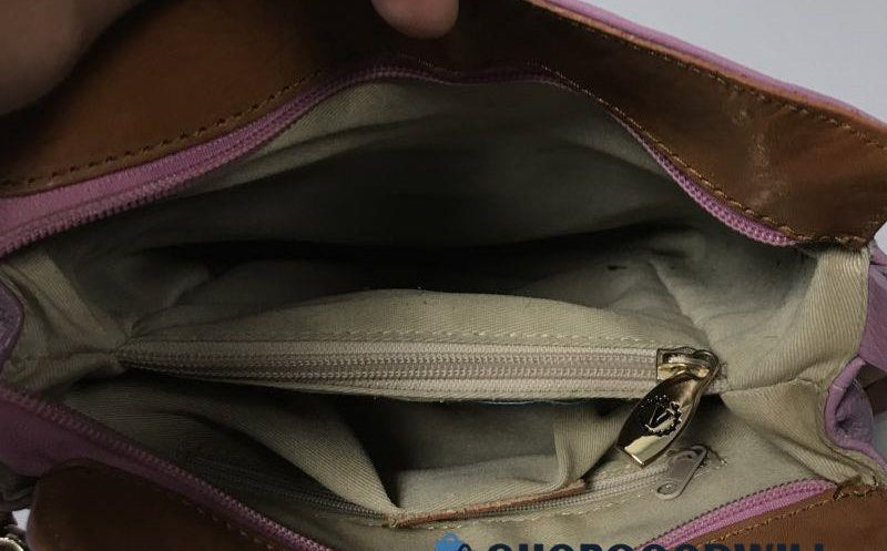 Pink lavender pebbled leather bucket-style crossbody bag with tan leather strap, view 2