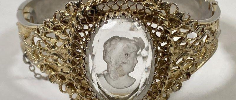 Signed Whiting and Davis gold-tone hinged bracelet with clear intaglio portrait cameo, view 6