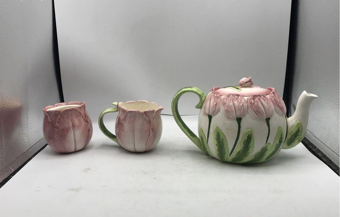 Pink tulip-shaped ceramic teapot with creamer and sugar bowl and green leaf accents, view 9
