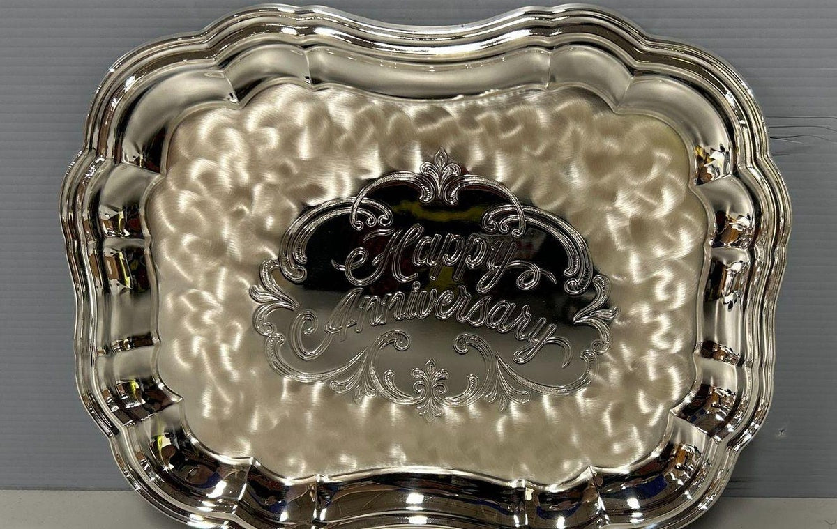 Silver-colored WMF Ikora scalloped serving plate with hammered center and raised Happy Anniversary, view 2