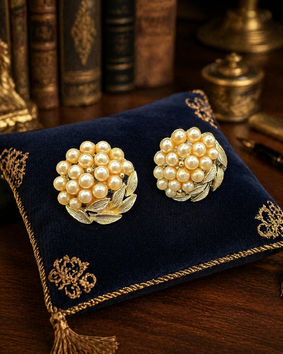 Signed Lisner gold-tone cluster clip earrings with cream faux pearls and leaf details