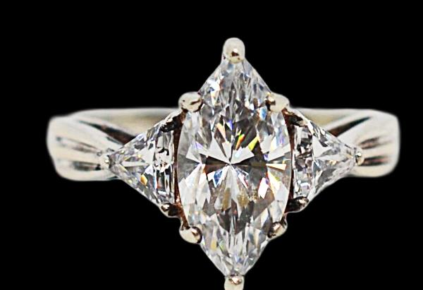 Silver-tone ring with marquise-style clear center stone and clear side stones, view 2