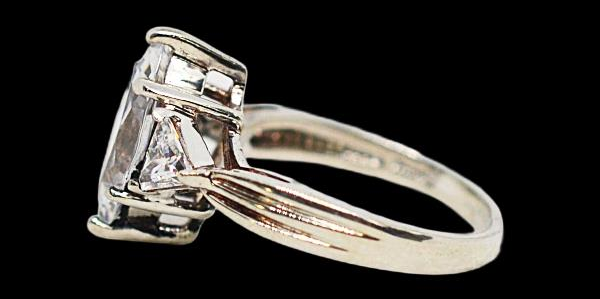 Silver-tone ring with marquise-style clear center stone and clear side stones, view 3