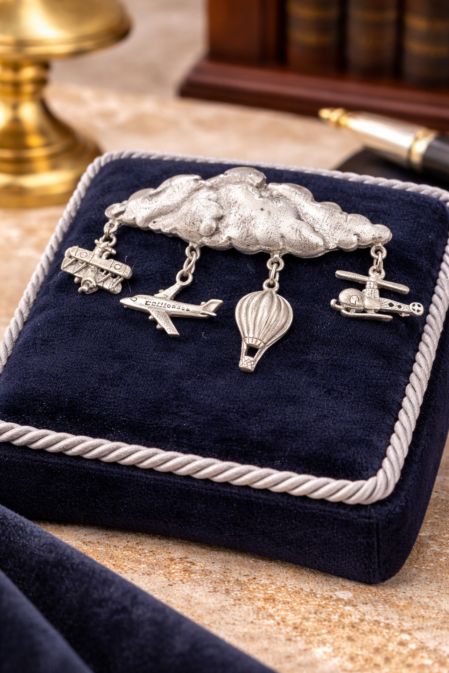 Signed JJ silver-tone cloud brooch with dangling airplanes, helicopter and hot air balloon