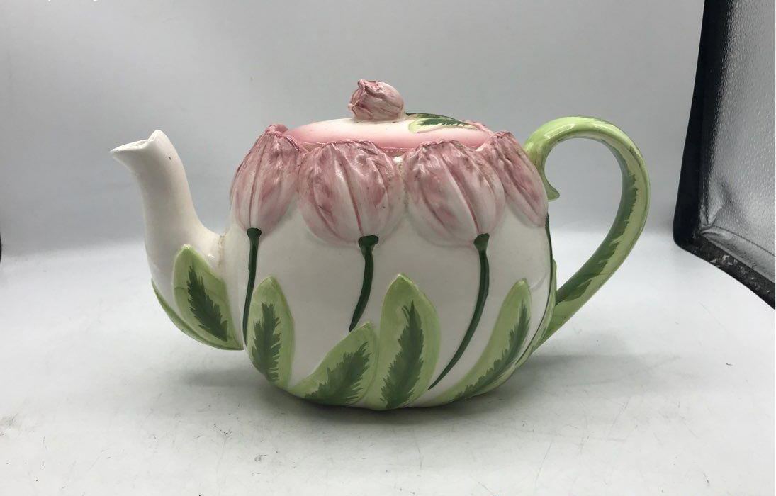 Pink tulip-shaped ceramic teapot with creamer and sugar bowl and green leaf accents, view 11