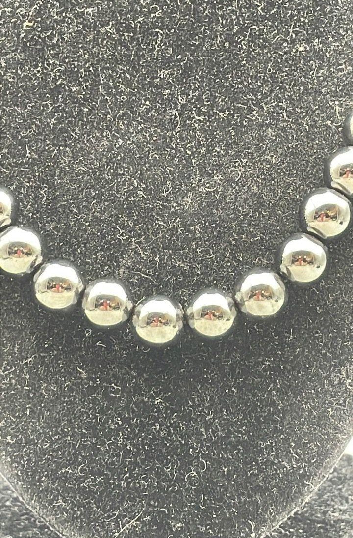 Graduated dark metallic bead necklace with silver spacers and lobster clasp, view 4
