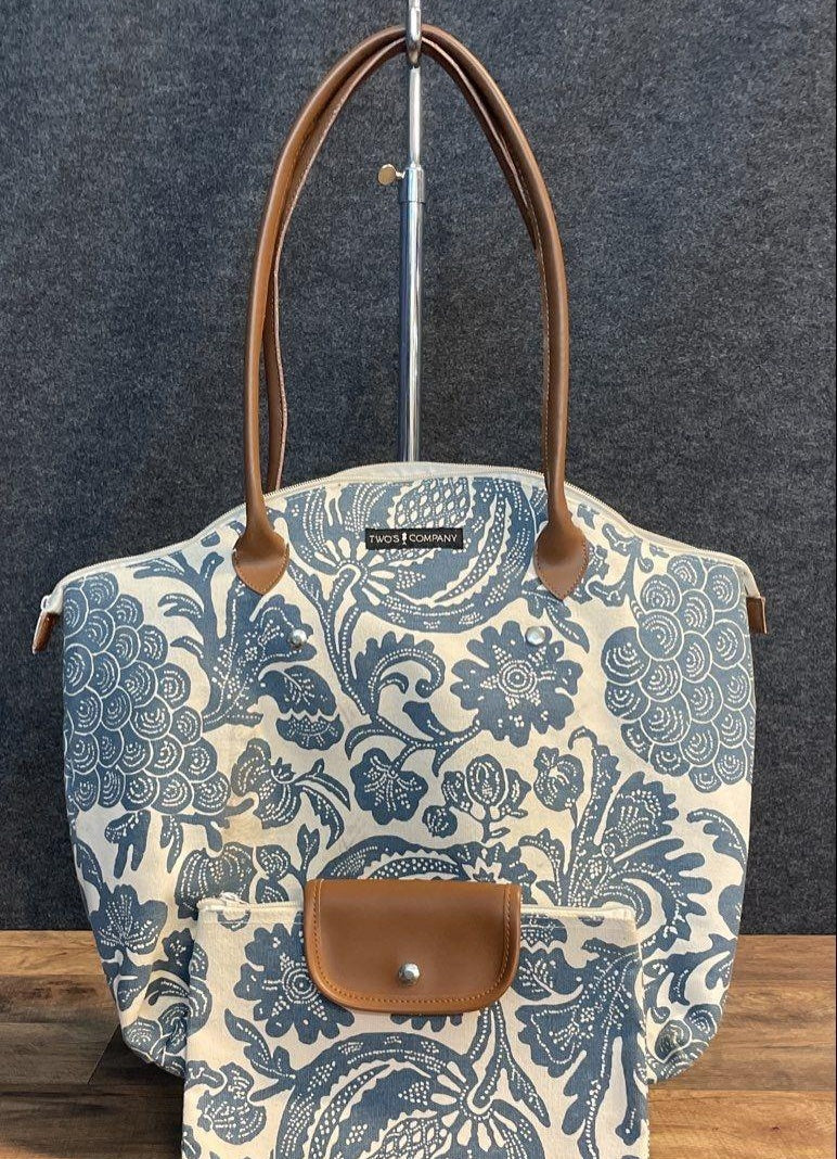 Blue and white floral canvas tote with tan handles and matching pouch, view 2