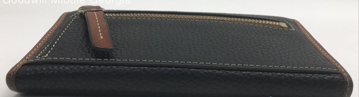 Dooney and Bourke black pebble grain leather clutch wallet with brown trim and front plaque, view 5