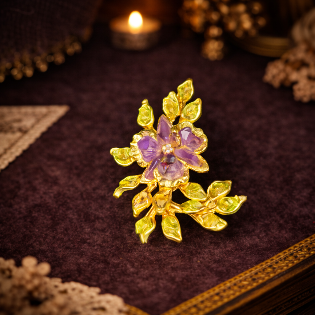Gold-tone floral spray brooch with pink rhinestone flower and leafy branch
