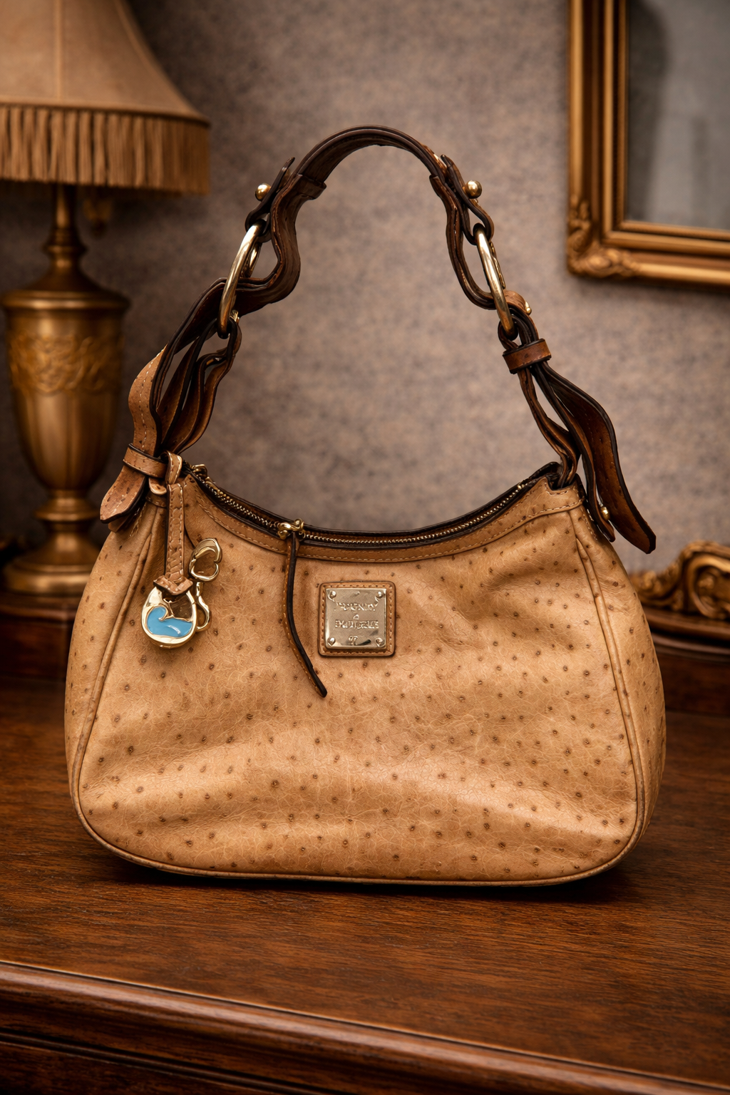 Dooney and Bourke tan ostrich-embossed leather hobo bag with duck charm