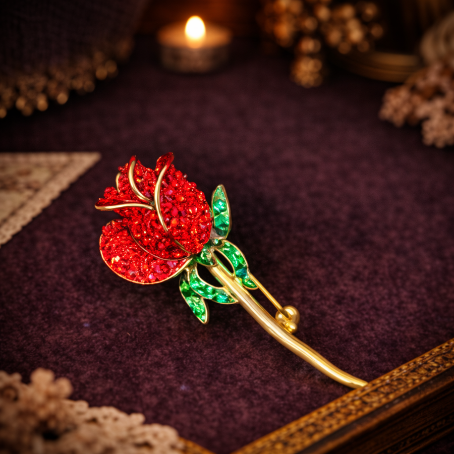 Signed Monet gold-tone long stem rose brooch with red enamel and green rhinestone leaves