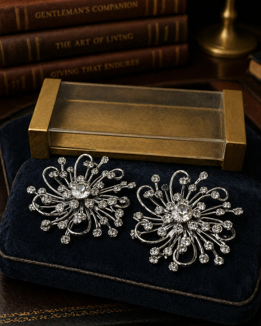 Sarah Coventry silver-tone starburst earrings with clear crystals and original packaging