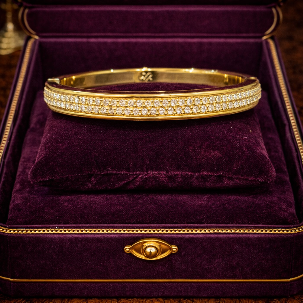 Tommy Bahama gold-tone hinged bangle bracelet with rows of clear rhinestones