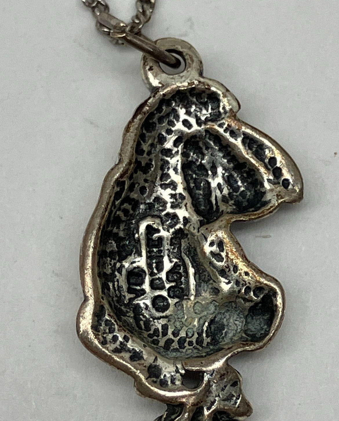 Silver Eeyore character pendant in a seated pose on a fine chain, view 4