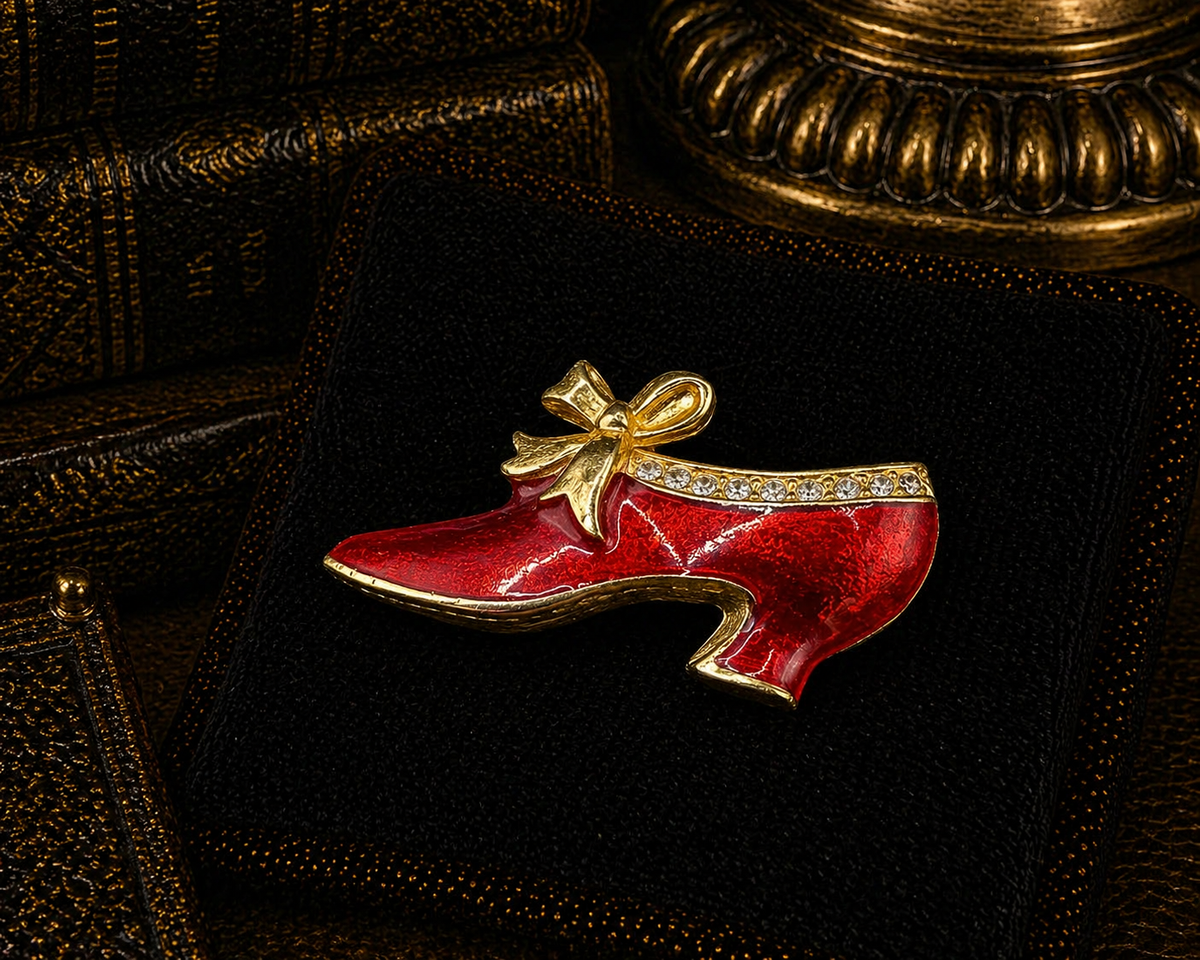 Glossy red enamel-style high heel shoe brooch with gold-tone edging, bow and clear crystals