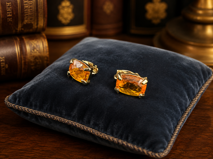 Signed Swarovski gold-tone clip earrings with faceted amber crystals