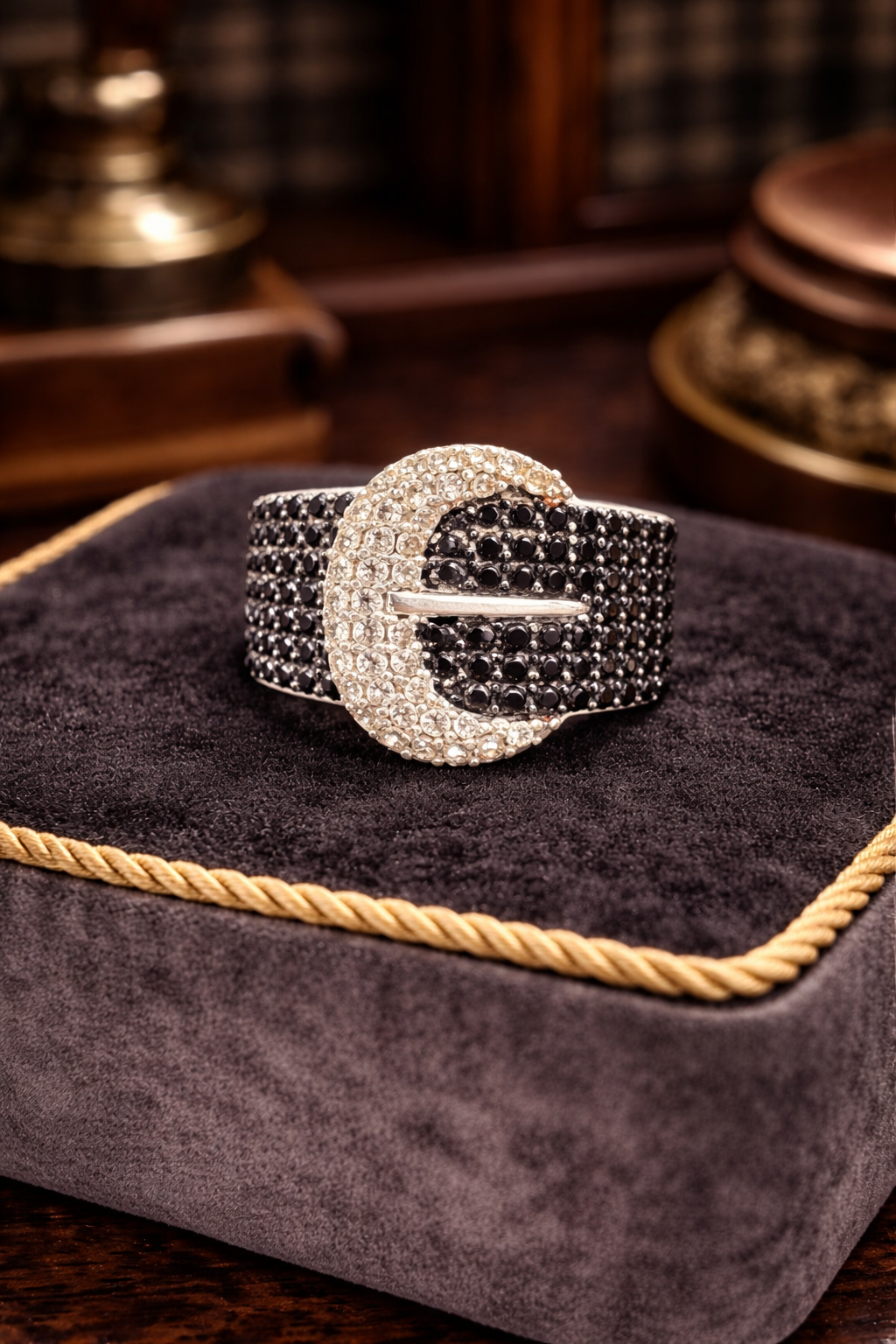 Silver-tone wide band buckle ring set with black crystals and clear crystal outline