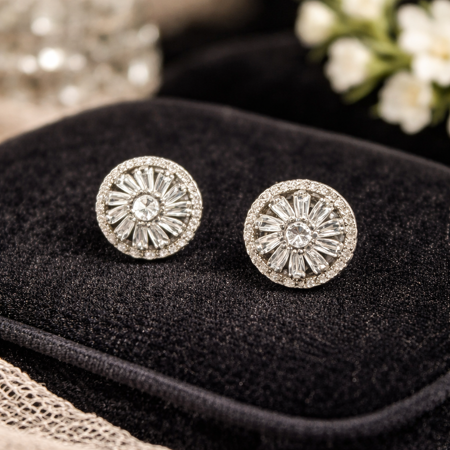 Silver-tone round starburst stud earrings with clear center stones