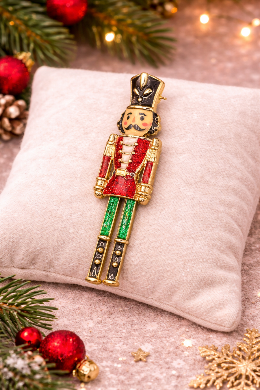 Articulated nutcracker soldier Christmas brooch with red glitter enamel jacket and green trousers
