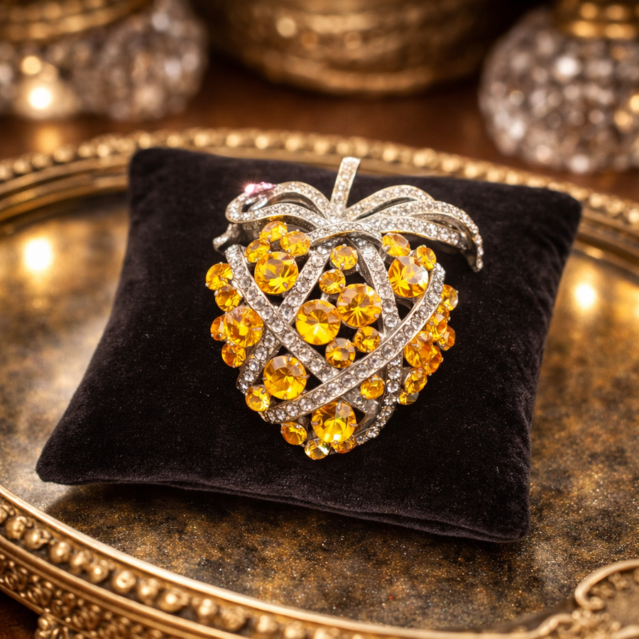 Silver-tone strawberry brooch with orange rhinestones, clear crystal accents and textured leaves